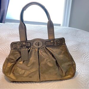 Vintage Coach Garnet 13915. Gold patent leather with beautiful lavender lining.